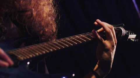 Long-haired guitarist close up playing t... | Stock Video | Pond5