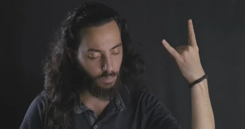 Long haired handsome young rocket boy listening metal music. Bearded guy's st Stock Footage 139825906