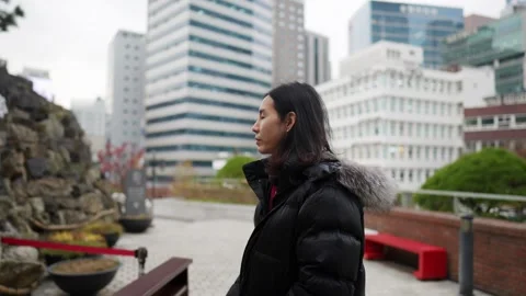 A long-haired Korean man in his 30s taking a walk around a church Stock Footage 258906515