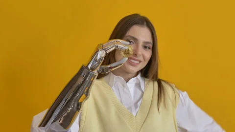 Long haired lady with bionic arm holds gold bitcoin in hand Stock Footage 150222145