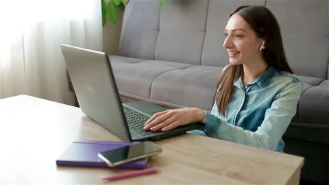 Long haired lady making video cal at home Stock Footage 134877483