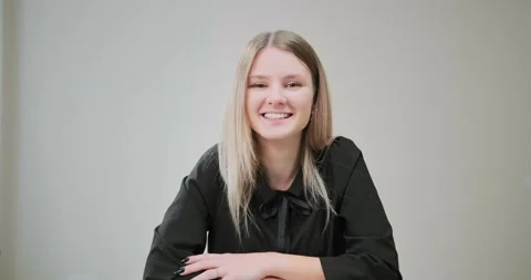 Long haired lady smiles sitting at online job interview Stock Footage 146255194