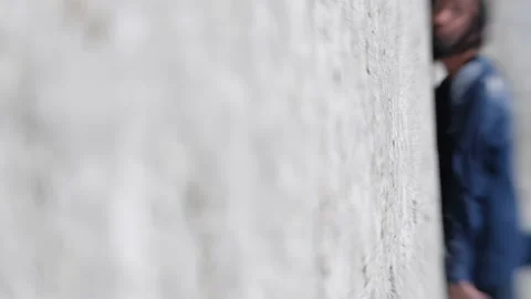 Long-haired man in dirty clothes falls on the hot sand Видео 232843702