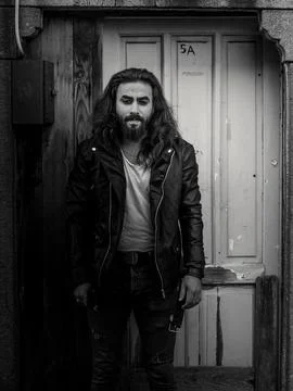 Long haired man into the door Stock Photos