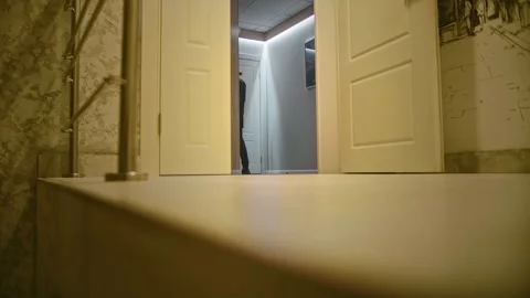 A long-haired man opens the door of a hotel room by applying an access card to Stock Footage 252274396