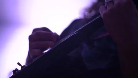 Long haired man plays modern bass guitar on stage in club Stock Footage 147522710
