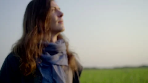 Long-haired man standing in rice field Stock Footage 63082872