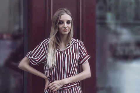 Long-haired model poses outside vintage cafe 写真素材