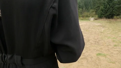 Long Haired Young Clergy is Walking to Bridge Footpath Through Coniferous Stock Footage 71633653
