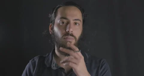 Long haired young man in depression, smoking. Cigarette and dark concept, wor Video stock 139825383