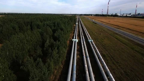 Long heating mains next to the highway, shooting from a drone Stock Footage 221089863