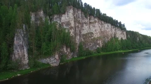 Long high cliff with wild forest on the top near river Stock-Footage 65317556