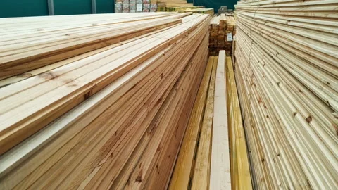 A long high stack of molded wooden planks, beams, siding for construction and re Stock Footage 130674574