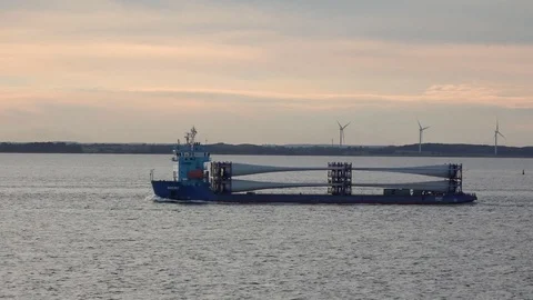 Long hopper barge sails along bank with windmills at sunset Stock Footage 113093728