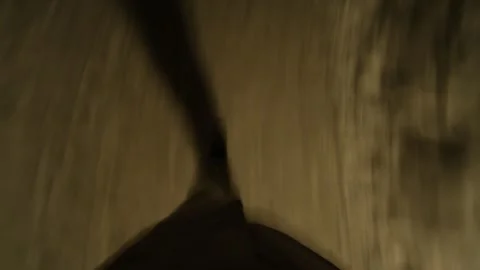Long human shadow walking on yellow asphalt at dark moody night. Stock Footage 331216544