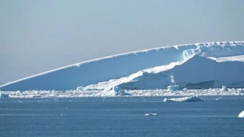 Long iceberg drifting calm ocean Antarctica, 4K Stock Footage 332372881