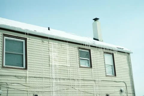 Long icicles on front of the house. Stock Photos