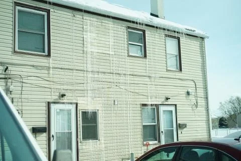 Long icicles on front of the house. Stock Photos