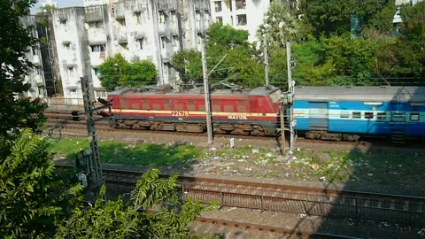 Long Indian Passenger express train in speed near Dahisar station Mumbai India Stock Footage 153167241