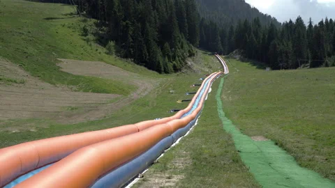 Long inflatable water slide on mountain in Bansko, Bulgaria Stock Footage 146320756