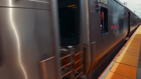Long Island Rail Road Train Arriving at Valley Stream Station on a Bright Day Stock Footage 338320944
