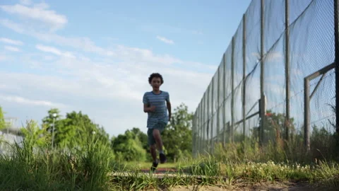 Long jump competition. A curly-haired schoolboy teenager in a sports uniform Stock Footage 167269433