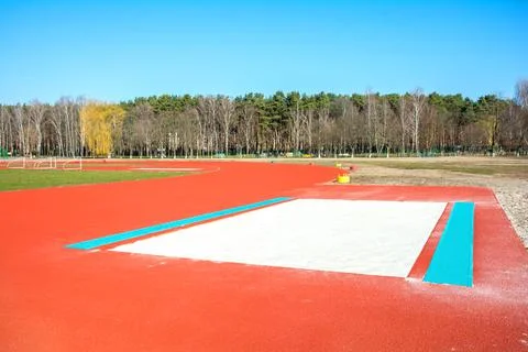 Long jump pit. Jumping pit with white sand. Sport Stock Photos