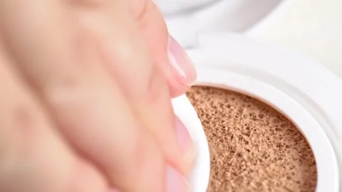 Long-lasting cushion foundation, macro. Pressing the puff against the cushi.. Stock Footage 284420120