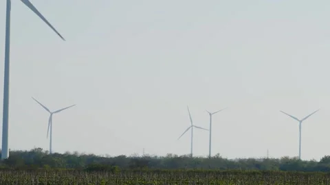 Long lens 4k footage of wind turbines producing green energy Stock Footage 287115553