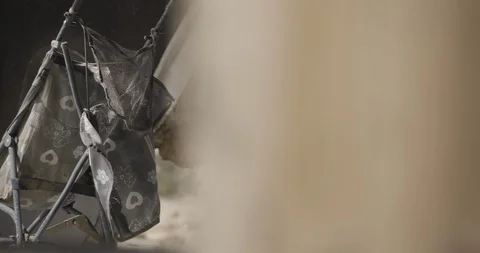 Long Lens Close Up of Baby Stroller in Burnt Out Home Stock Footage 89942226
