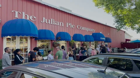 A long of line of people in front of Julian Pie Company Stock Footage 320396921