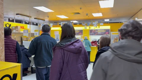 A long line of people at the post office counter at Kaufring in Weil am Rhein Stock Footage 332974542