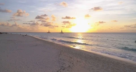 Long low fly over white beach and water with sunset view Stock-Footage 97171170