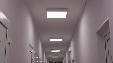 A long medical corridor in a hospital where the lights go off and then back Stock Footage