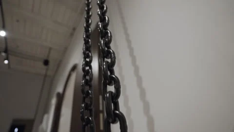 Long metal chain extends upwards with hook and wooden bucket Stock-Footage 295840160
