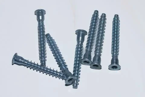 Long metal silver threaded screws on a white background. Stock Photos