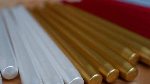Long multicolor taper candles on light wooden surface, close-up  Stock-Footage 89240223