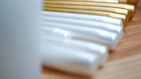 Long multicolor taper candles on light wooden surface, close-up  Video stock 89240647