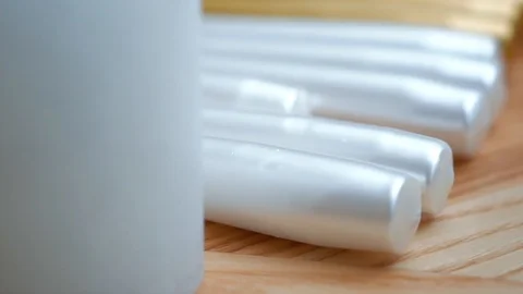 Long multicolor taper candles on light wooden surface, close-up  Video stock 89240648