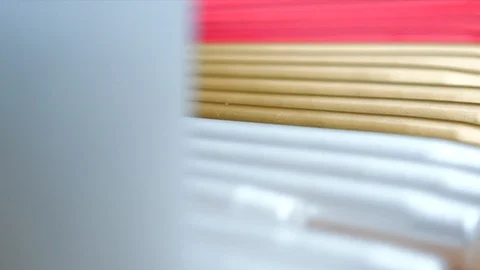 Long multicolor taper candles on light wooden surface, close-up  Video stock 89240661