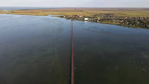A long narrow bridge over a large lake or estuary. Stock Footage 140134126