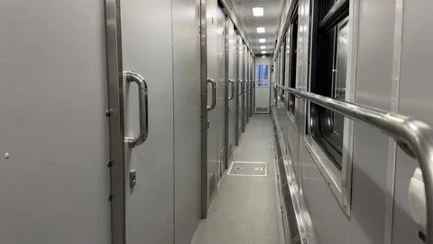 A long narrow corridor inside a modern train carriage Stock Footage 312400677