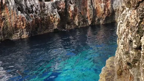 A long narrow stone path under the rock leads towards the Blue Grotto. Stock Footage 263828216
