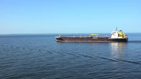 Long oil tanker with red deck and white steel cranes sails Stock Footage 113459201