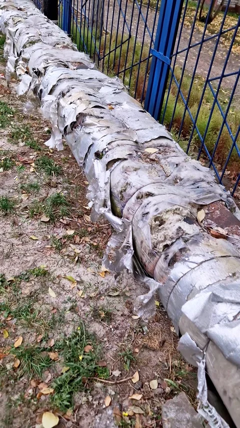 Long Outdoor Heating Pipe with Tattered Insulation Stock Footage 325218340