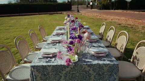 Long outdoor wedding reception table on a lawn push in Stock-Footage 347969236