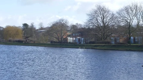 Long pan of a large blue windswept lake in Lichfield Stock Footage 94591130