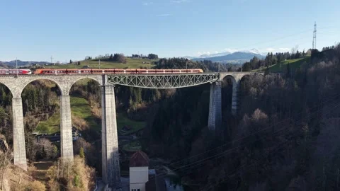 Long Passenger Train Crossing Tall Railway Viaduct Static Aerial View 스톡 동영상 330082864