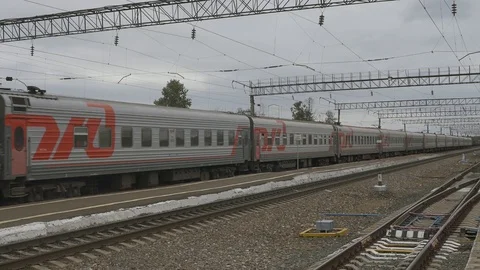 A long passenger train is passing by. Stock Footage 114497569