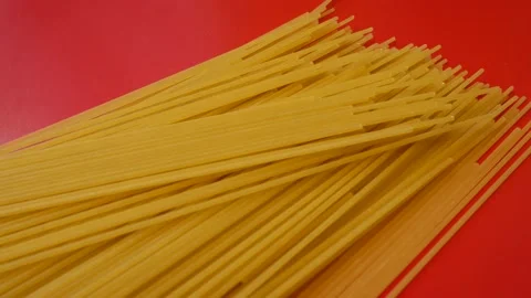 Long pasta on red background Stock Footage 163030611